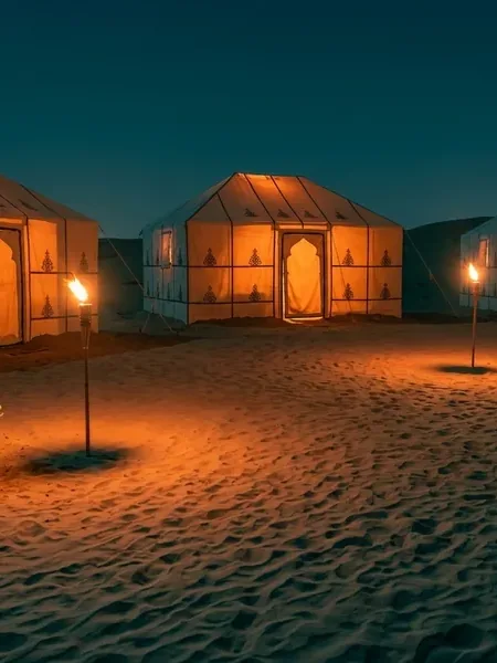 A camp pitched at dusk, the setting for a residential school camping programme.