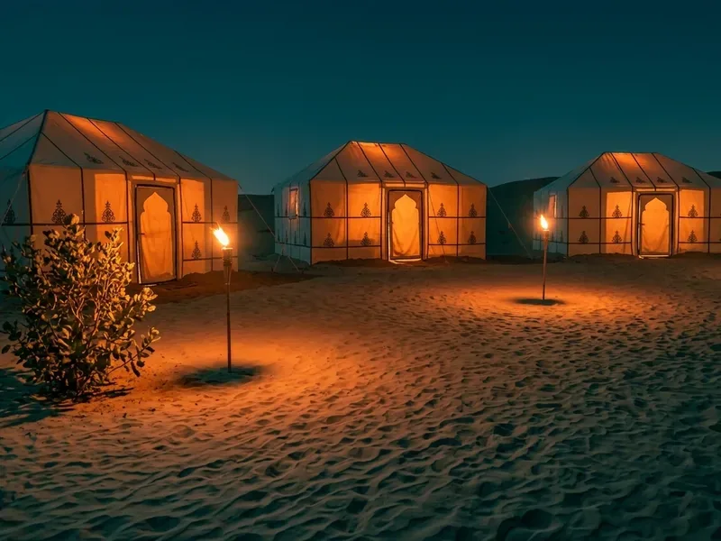 A camp pitched at dusk, the setting for a residential school camping programme.
